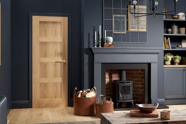 Classic shaker style solid wood interior door in a luxury living room with dark walls and fireplace, perfect for custom homes — Canada Wood Doors