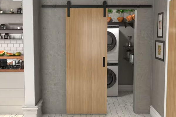 Contemporary sliding barn-style solid wood door with exposed black track hardware, ideal for residential laundry and pantry spaces — Canada Wood Doors